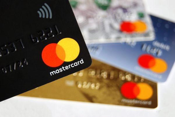 Zbliżenie na kilka kart kredytowych Mastercard w różnych kolorach, symbolizujących limity i zobowiązania
